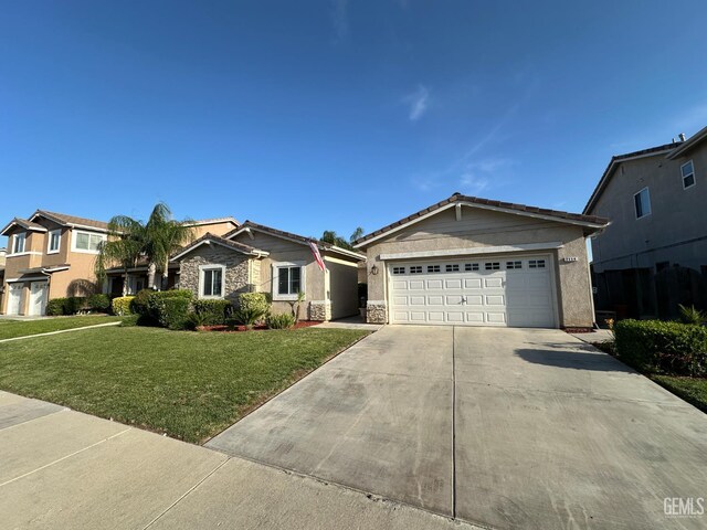 2114 Via Lazio Ave, Delano, CA 93215 - view of front of house with driveway, a front yard, a garage, stucco siding, and a tile roof