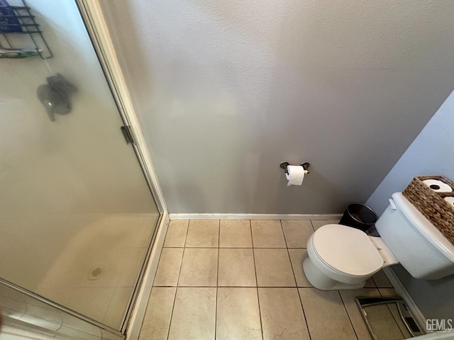 2114 Via Lazio Ave, Delano, CA 93215 - full bath with toilet, a stall shower, tile patterned flooring, and baseboards