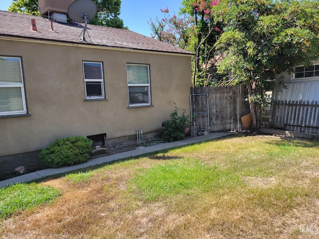 2915 Cedar St, Bakersfield, CA 93301 - view of property exterior featuring a gate, stucco siding, and a shingled roof