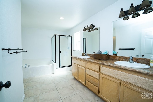 bathroom with tile patterned floors, vanity, and shower with separate bathtub