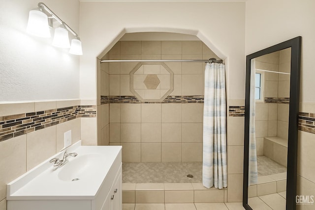 701 Burnett Dr, Bakersfield, CA 93307 - bathroom featuring a shower stall, vanity, and tile walls