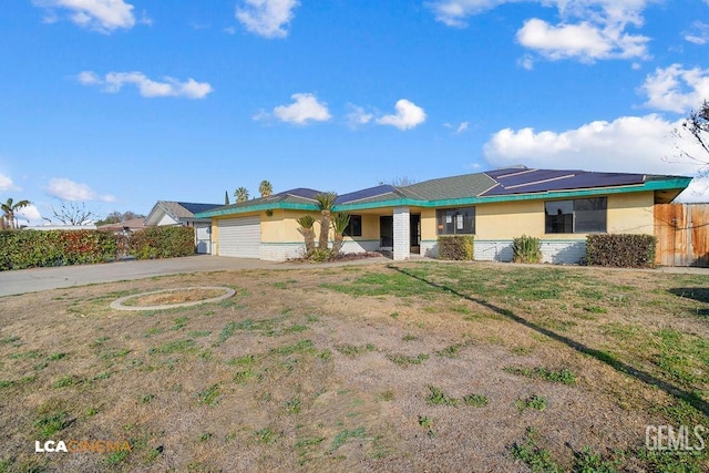 single story home with a garage and a front yard