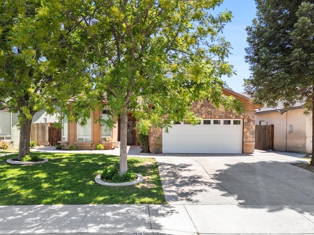 231 Sunny Meadow Dr, Bakersfield, CA 93308 - view of property hidden behind natural elements featuring stone siding, concrete driveway, and an attached garage
