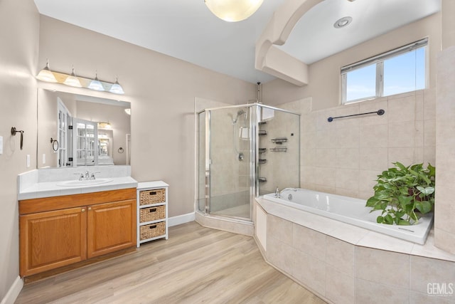 231 Sunny Meadow Dr, Bakersfield, CA 93308 - bathroom featuring a stall shower, a bath, vanity, and wood finished floors