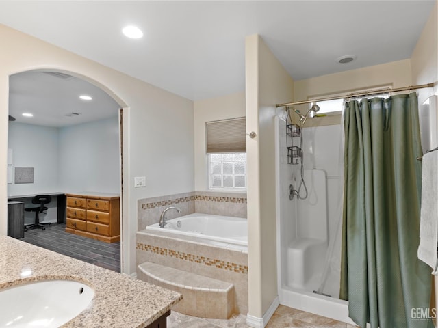 bathroom featuring plus walk in shower and vanity