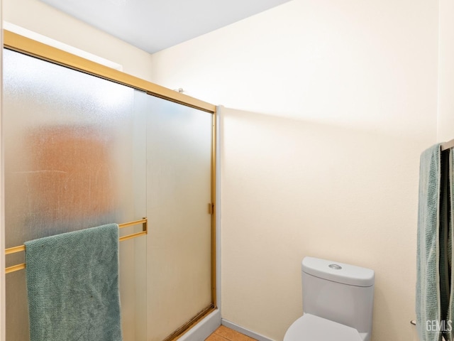 bathroom featuring toilet and walk in shower