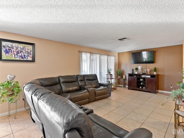 living room featuring light tile patterned flooring and a textured ceiling