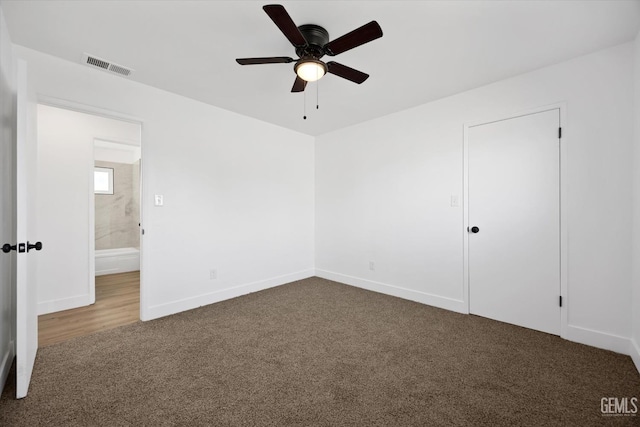 unfurnished bedroom with carpet floors, visible vents, ceiling fan, and baseboards