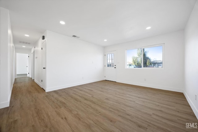 unfurnished room featuring dark wood-style floors, visible vents, and recessed lighting