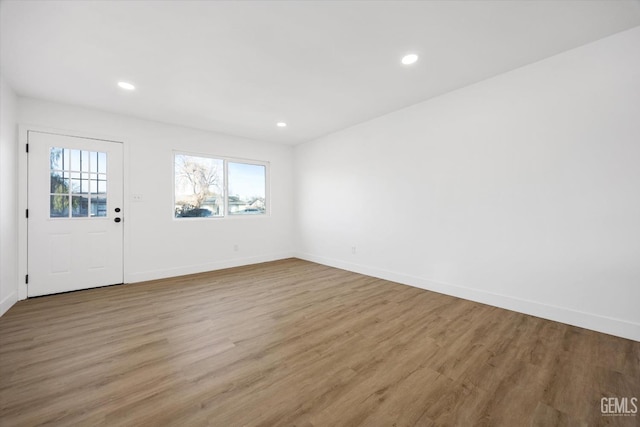 entrance foyer featuring plenty of natural light, baseboards, and wood finished floors