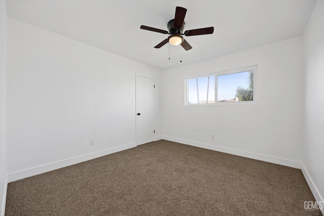 unfurnished room with ceiling fan, dark colored carpet, and baseboards