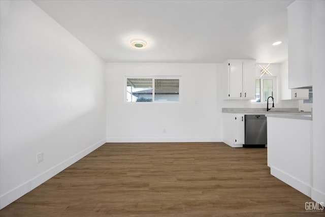 kitchen featuring white cabinets, dark wood-style flooring, light countertops, and dishwasher