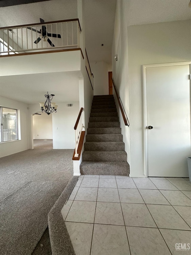 5821 Willowcrest St, Bakersfield, CA 93313 - stairs with a chandelier, a towering ceiling, and ceiling fan