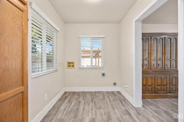 1701 Elm St, Bakersfield, CA 93301 - laundry room featuring hookup for an electric dryer, light wood-style flooring, hookup for a washing machine, and baseboards
