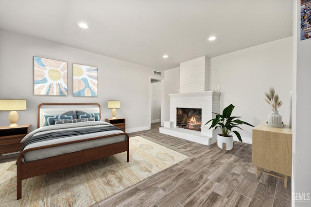 1701 Elm St, Bakersfield, CA 93301 - bedroom featuring wood finished floors, baseboards, a fireplace, and recessed lighting