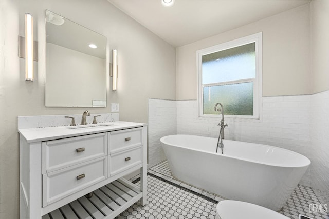 1701 Elm St, Bakersfield, CA 93301 - bathroom with tile walls, vanity, a freestanding bath, wainscoting, and recessed lighting
