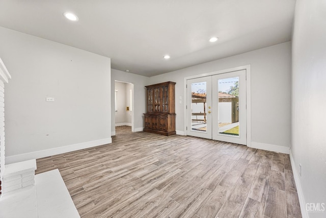 1701 Elm St, Bakersfield, CA 93301 - unfurnished living room featuring french doors, light wood-style flooring, baseboards, and recessed lighting