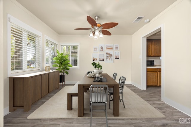 1701 Elm St, Bakersfield, CA 93301 - dining space with a ceiling fan, wood finished floors, ornamental molding, and baseboards