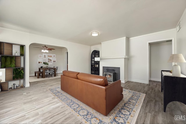 1701 Elm St, Bakersfield, CA 93301 - living area with arched walkways, a ceiling fan, wood finished floors, and baseboards
