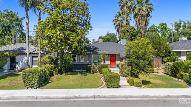 1701 Elm St, Bakersfield, CA 93301 - view of property hidden behind natural elements with a front yard and stucco siding