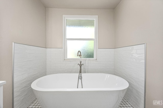 1701 Elm St, Bakersfield, CA 93301 - full bath featuring healthy amount of natural light, tile patterned floors, a freestanding tub, and tile walls