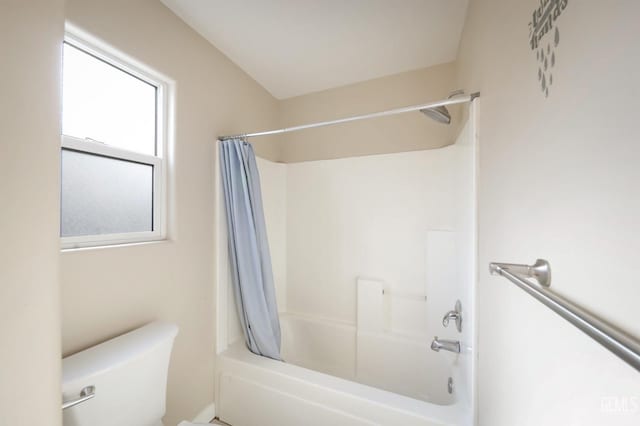 bathroom with shower / bathtub combination with curtain and toilet