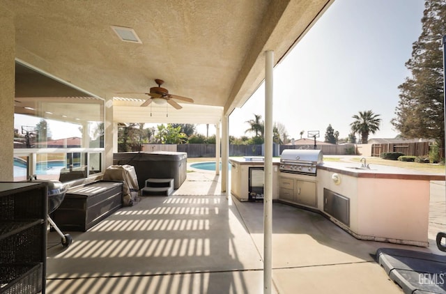 view of patio / terrace with sink, ceiling fan, a hot tub, area for grilling, and grilling area