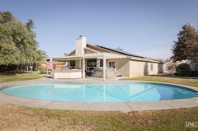 view of swimming pool featuring a pergola and a lawn