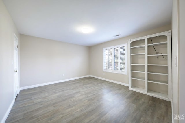 unfurnished room with hardwood / wood-style floors