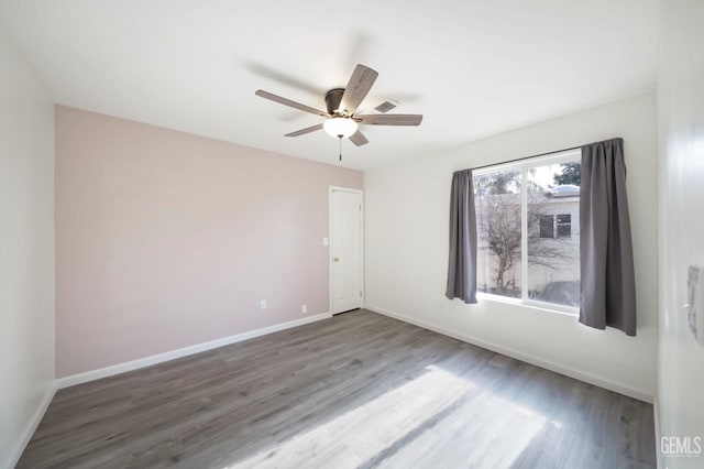 empty room with ceiling fan and wood-type flooring