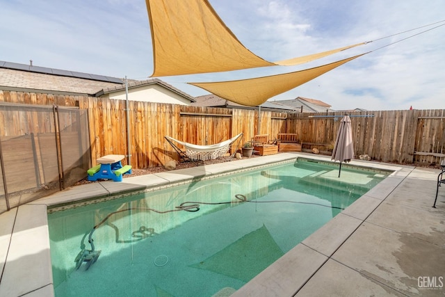 view of swimming pool featuring a patio area, a fenced backyard, and a fenced in pool