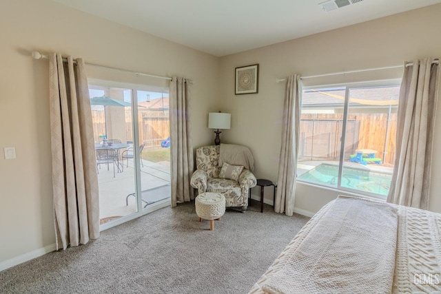 interior space featuring baseboards, carpet floors, visible vents, and access to exterior