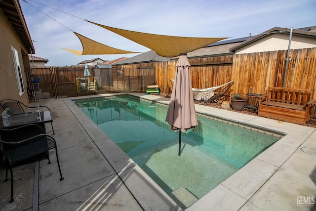 view of pool featuring a fenced in pool, a patio area, and a fenced backyard