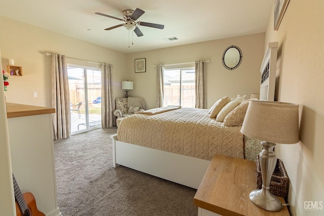 carpeted bedroom featuring access to exterior, visible vents, and a ceiling fan