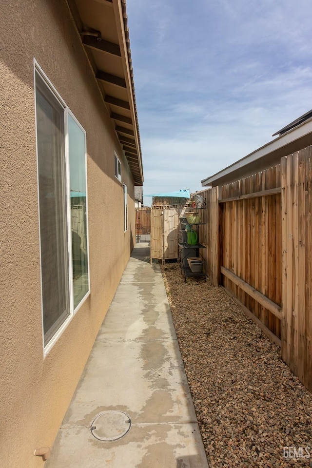 view of property exterior featuring a fenced backyard and stucco siding