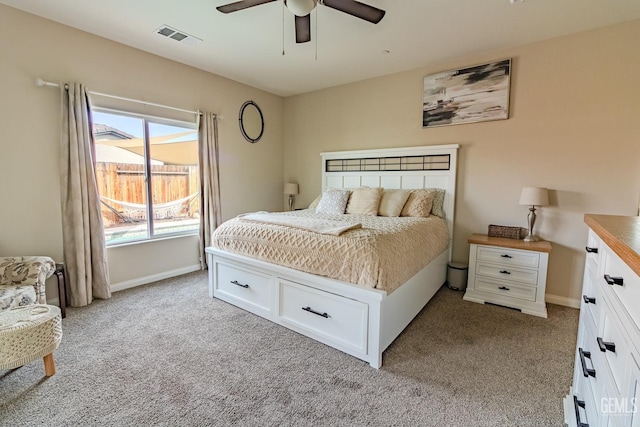 bedroom featuring baseboards, visible vents, and light colored carpet