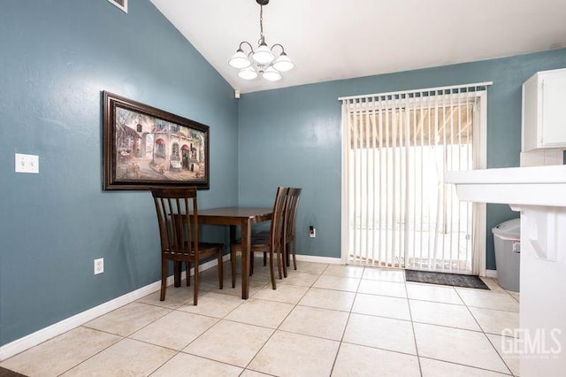 tiled dining area featuring an inviting chandelier and vaulted ceiling