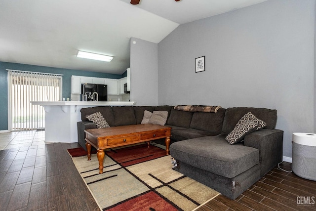 living room featuring vaulted ceiling and ceiling fan