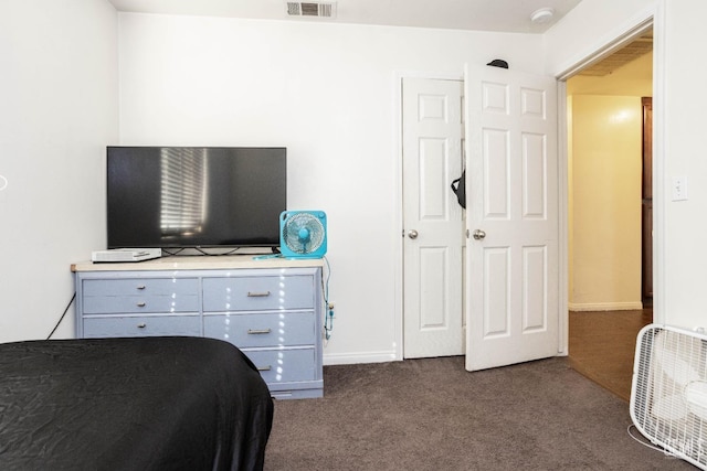 bedroom featuring dark carpet