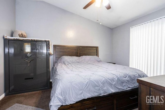 bedroom with dark carpet, vaulted ceiling, and ceiling fan