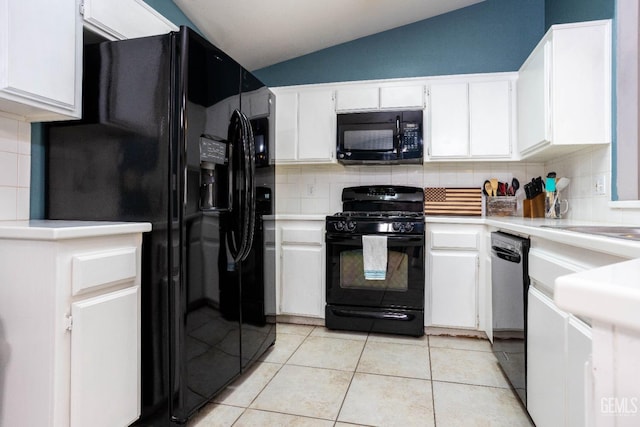 kitchen featuring black appliances, vaulted ceiling, light tile patterned floors, backsplash, and white cabinets