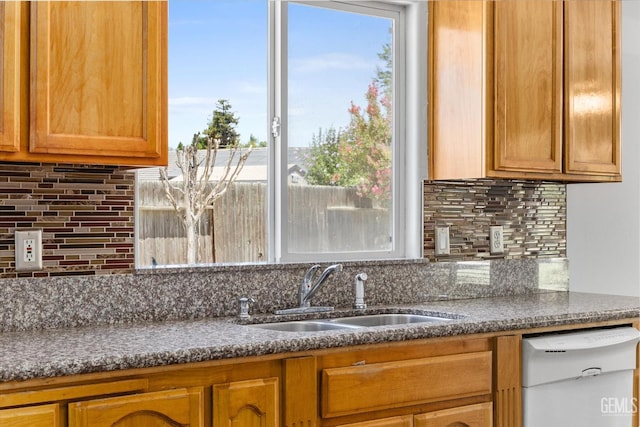 5702 San Pierre Ct, Bakersfield, CA 93308 - kitchen with dishwasher, decorative backsplash, brown cabinets, and dark stone countertops