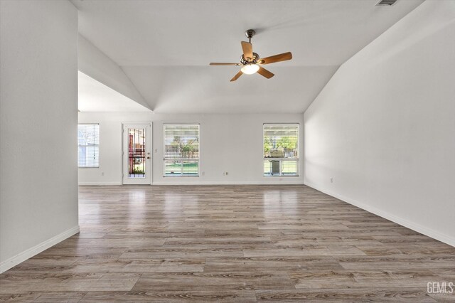 5702 San Pierre Ct, Bakersfield, CA 93308 - unfurnished living room featuring lofted ceiling, a ceiling fan, and wood finished floors