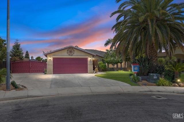 5702 San Pierre Ct, Bakersfield, CA 93308 - view of front of home featuring stucco siding, driveway, a garage, and a gate