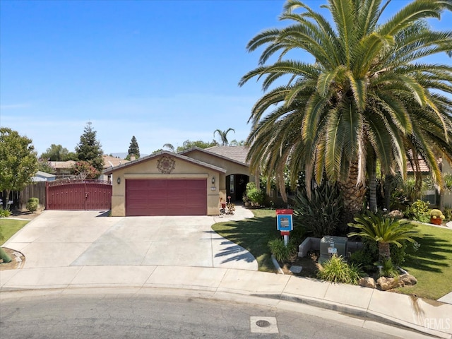 5702 San Pierre Ct, Bakersfield, CA 93308 - obstructed view of property featuring stucco siding, an attached garage, driveway, a gate, and a front lawn