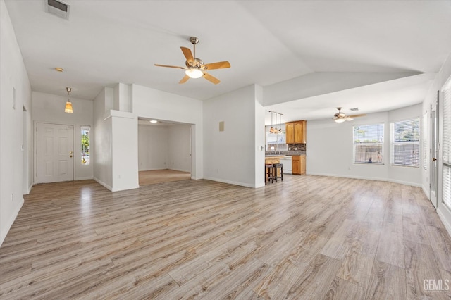 5702 San Pierre Ct, Bakersfield, CA 93308 - unfurnished living room with ceiling fan, healthy amount of natural light, vaulted ceiling, and light wood-style floors