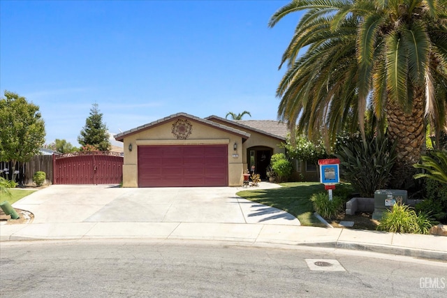5702 San Pierre Ct, Bakersfield, CA 93308 - view of front of property with an attached garage, concrete driveway, stucco siding, and a gate