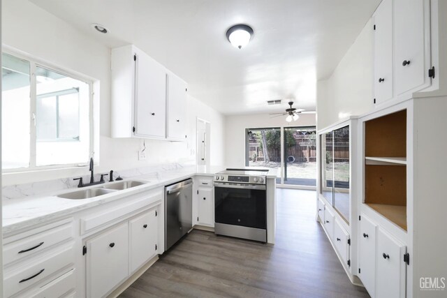 1312 Shattuck Ave, Bakersfield, CA 93305 - kitchen with stainless steel appliances, a ceiling fan, white cabinetry, a peninsula, and wood finished floors