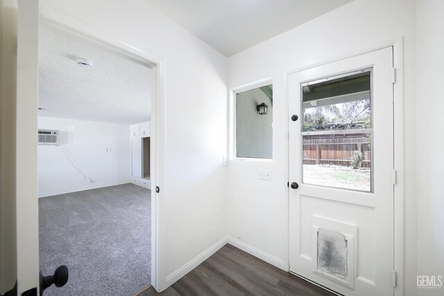 1312 Shattuck Ave, Bakersfield, CA 93305 - doorway with a wall mounted AC and a textured ceiling