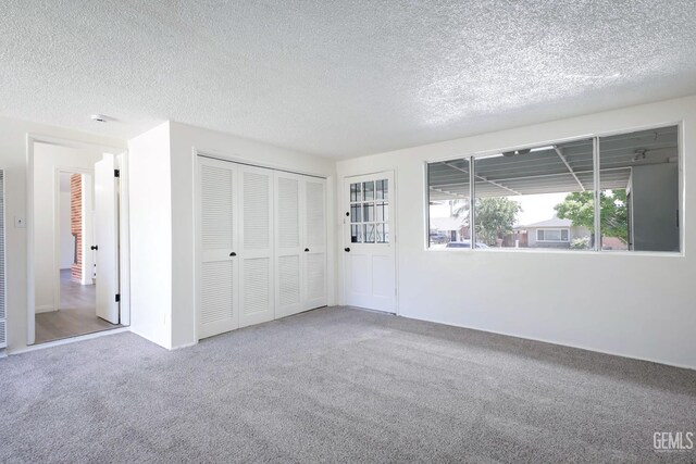 1312 Shattuck Ave, Bakersfield, CA 93305 - unfurnished bedroom with carpet, a textured ceiling, a heating unit, and a closet